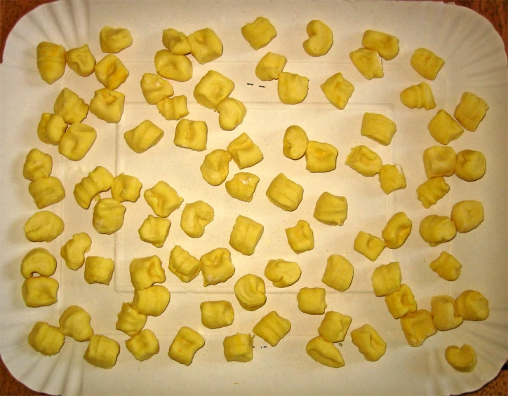 sliced yellow squares of cut into smaller pieces on a paper plate