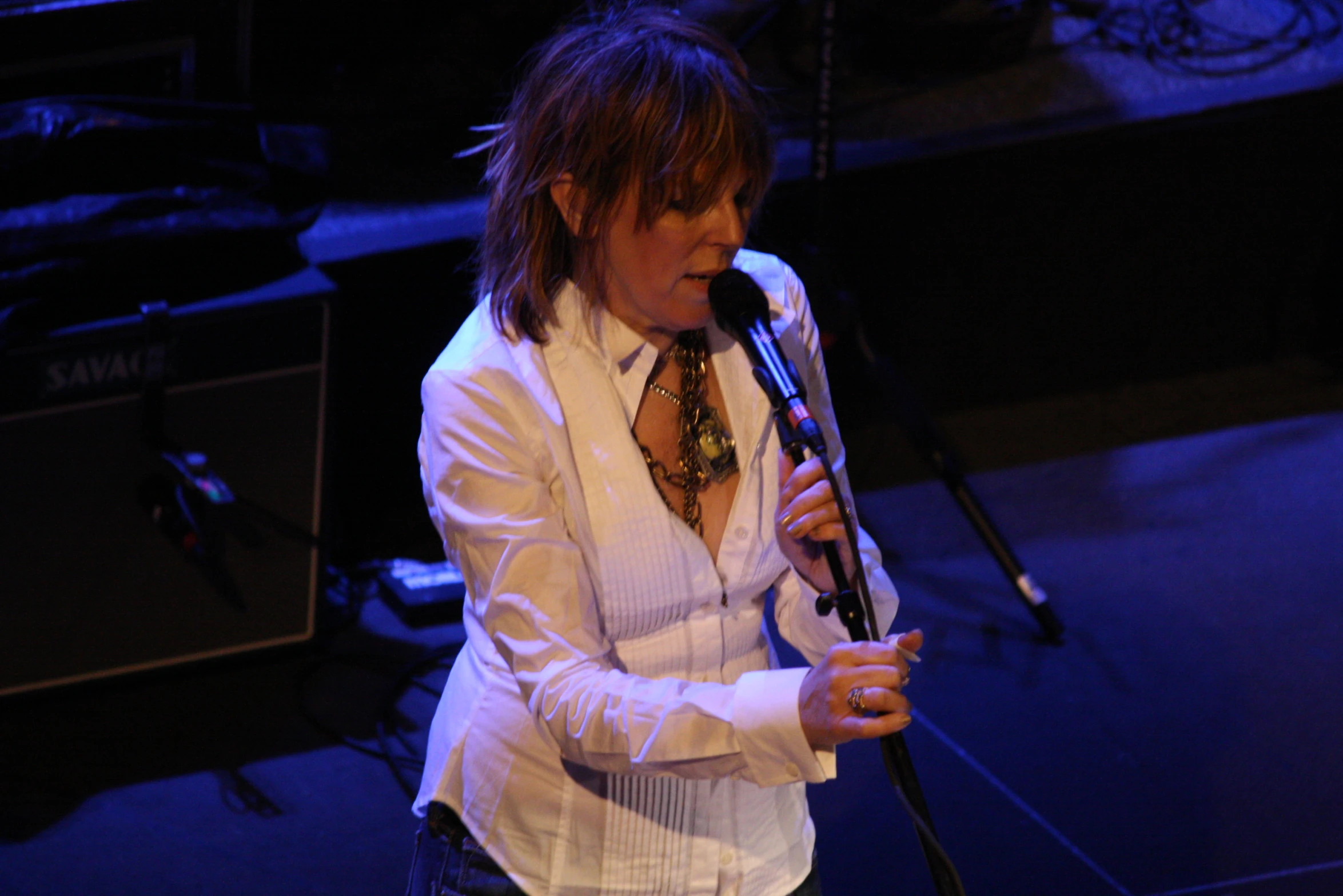 a man is holding a microphone and is standing in front of his microphone