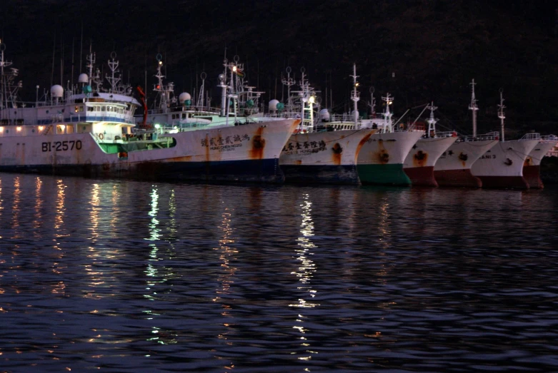 several ships are docked in a large body of water