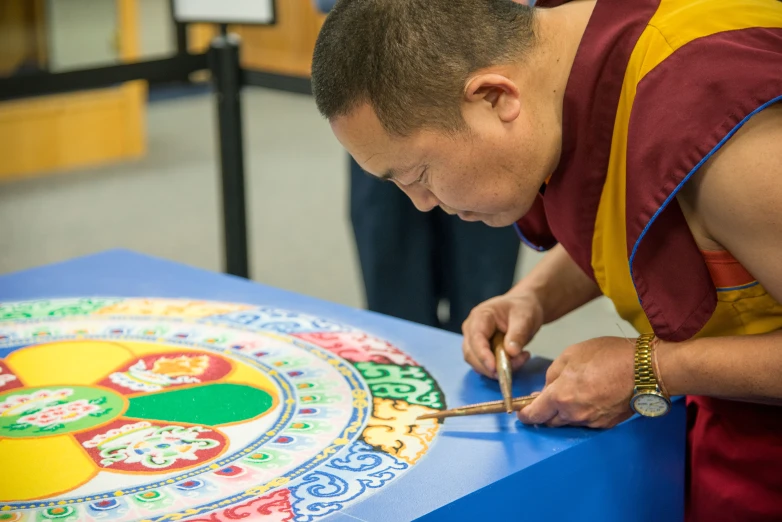 there is a man with a big medallion drawing on a table