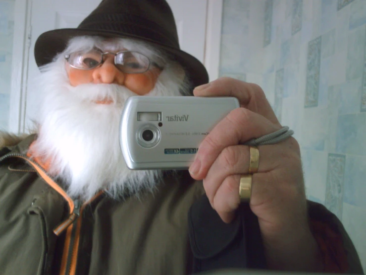 a man taking a po with a camera and a long beard