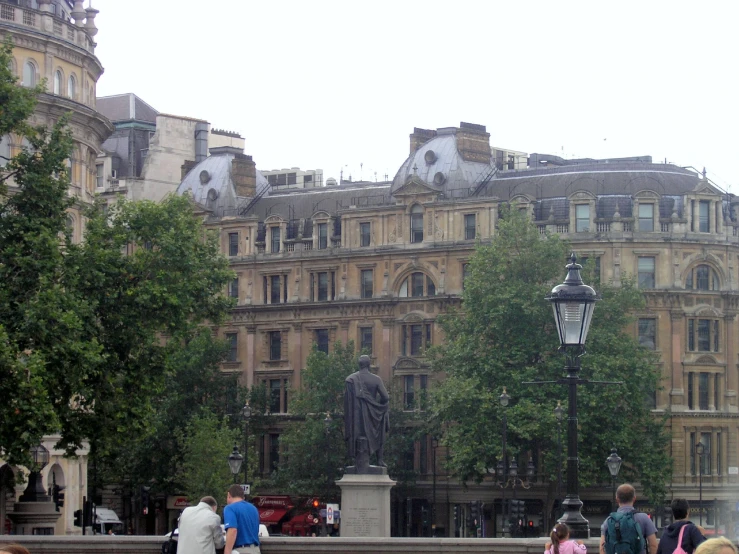 a bunch of people standing by some buildings