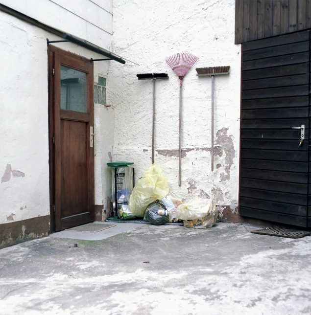 a garbage bag sits outside the entrance to an old house