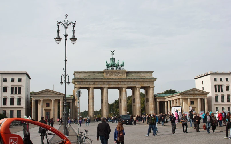 a number of people in front of some buildings