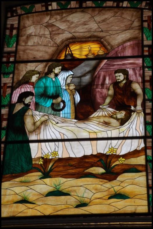 a stain glass image showing jesus on the bed