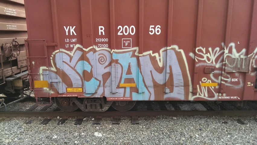 a train car with graffiti spray painted on it