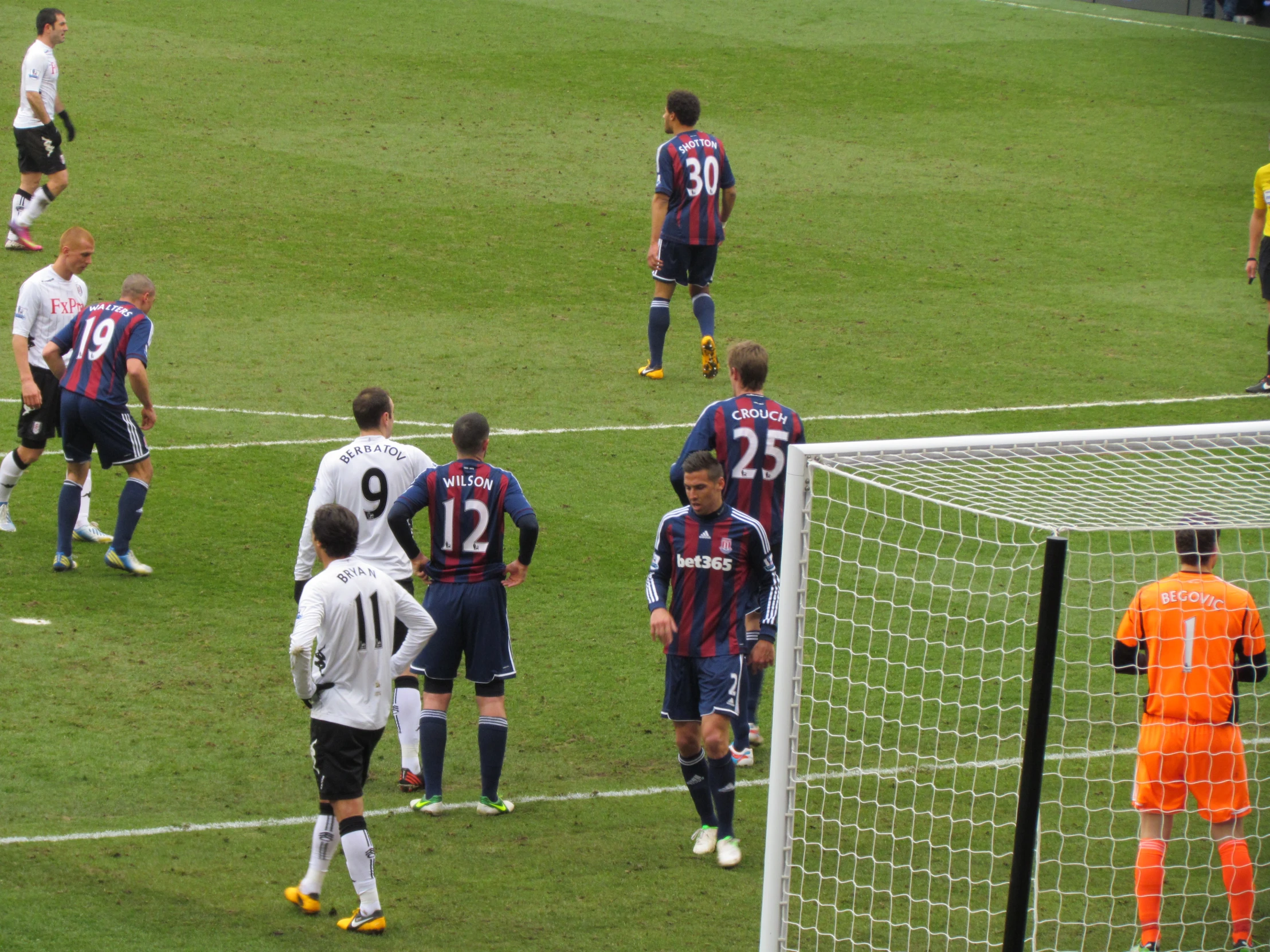 soccer players playing soccer on a field