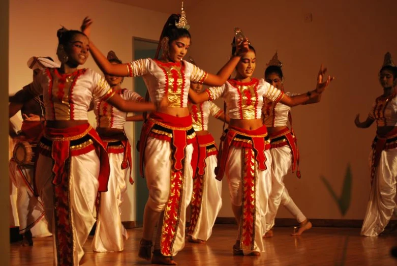 a group of young children are dancing