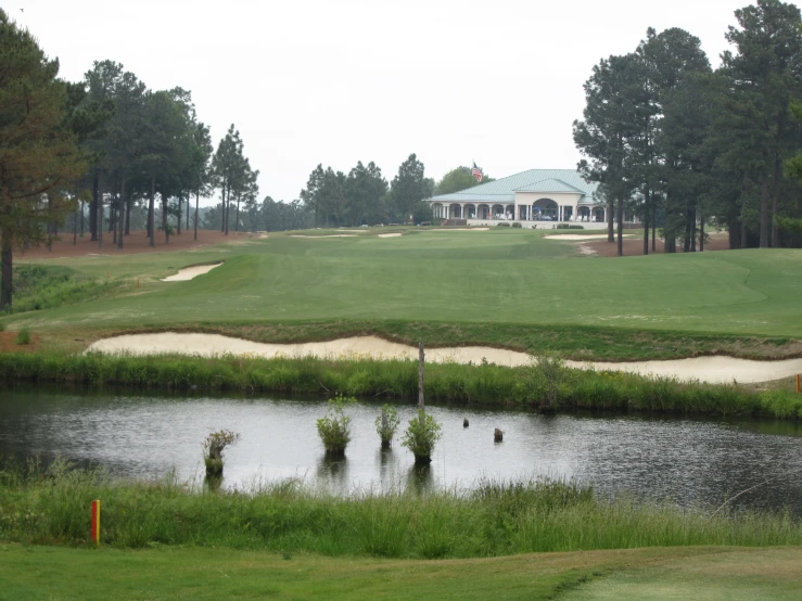 a view of a golf course and pond