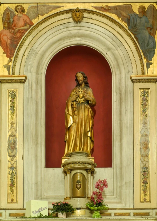 gold statue with angel on a large golden statue