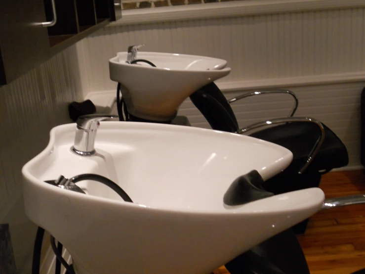 the bathroom sink has two black and white faucets