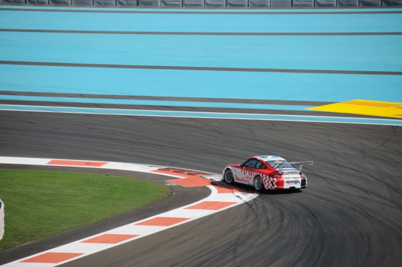 a person drives a racing car around the track