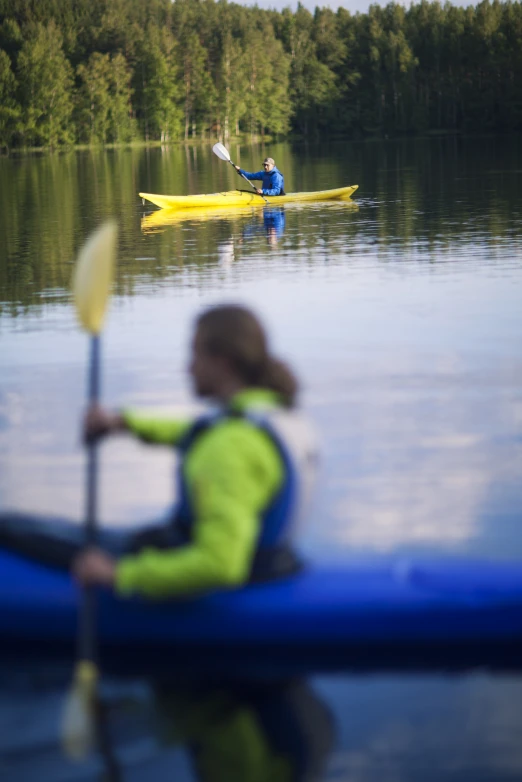 two people kayaking in small boat on water