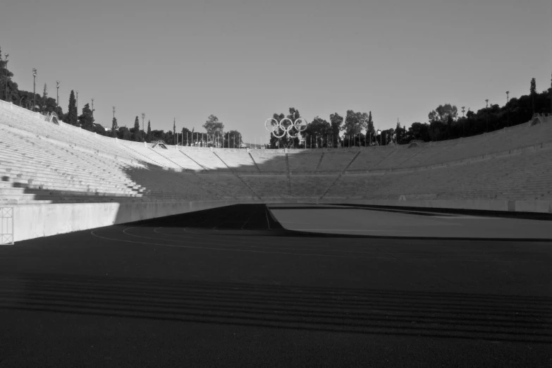 an empty stadium filled with people walking on the grass