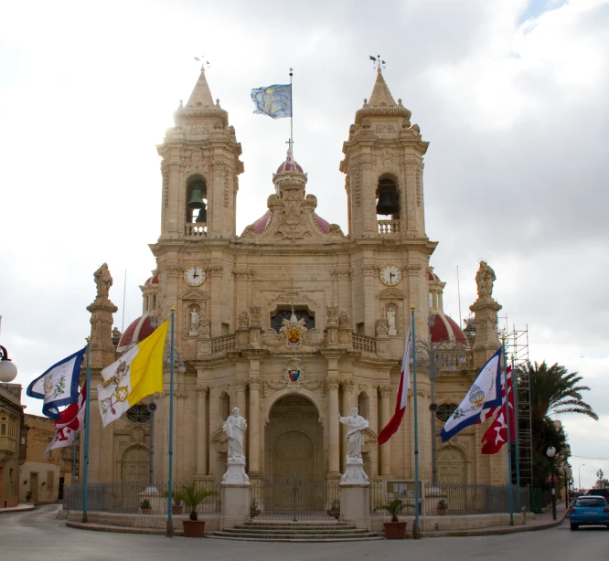 an old, gold building has a clock tower at the top