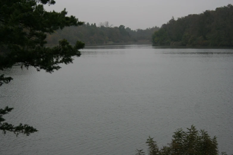 a lone bench in front of a body of water