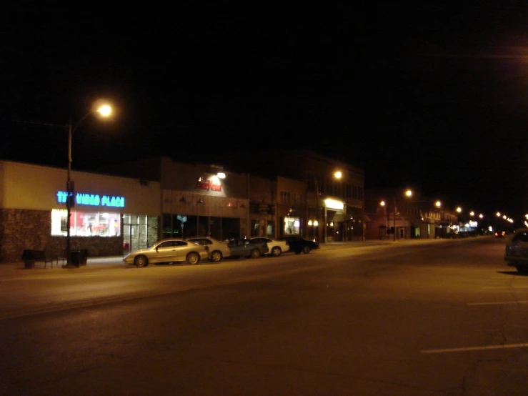 the lights are on in the evening on a street