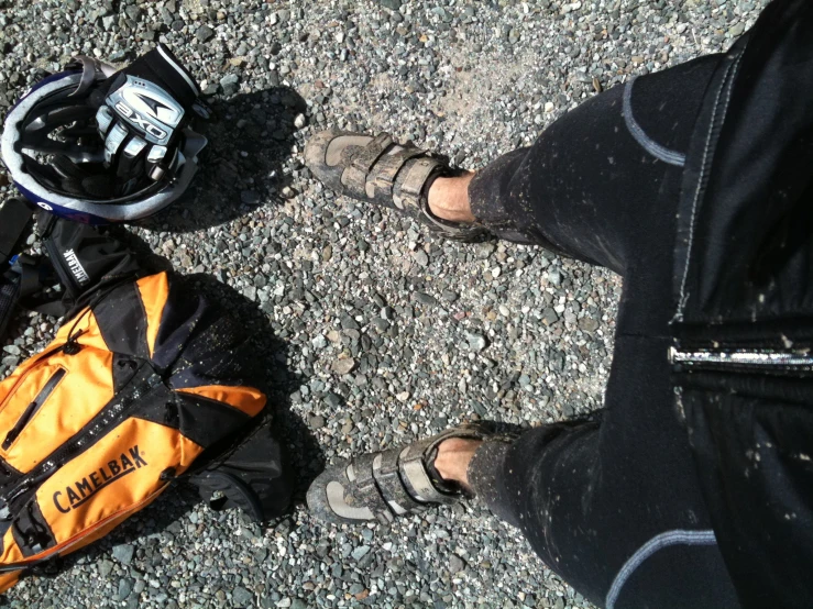 an upside down view of a person wearing athletic shoes and hiking gear