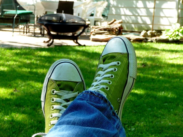 an image of person feet wearing green tennis shoes