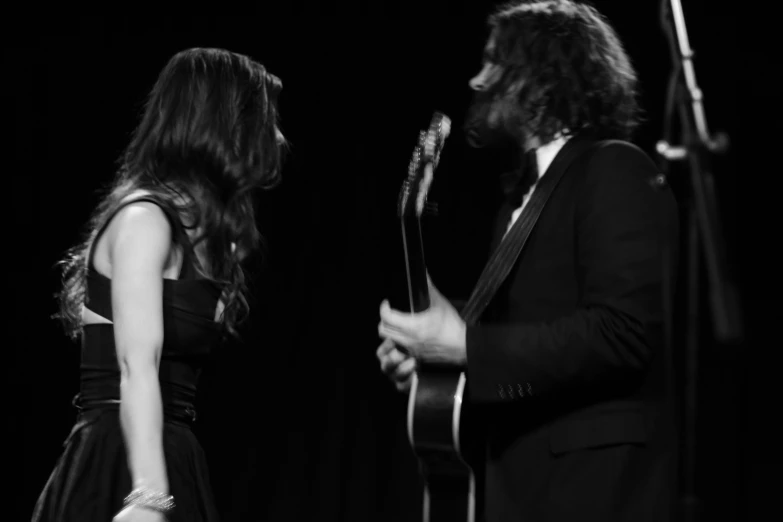 a man standing in front of a woman on top of a stage