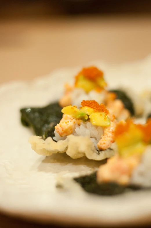 food with various kinds of vegetables is on a white plate