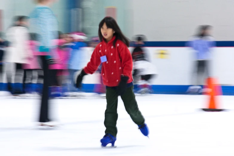 a woman ice skating on an indoor rink