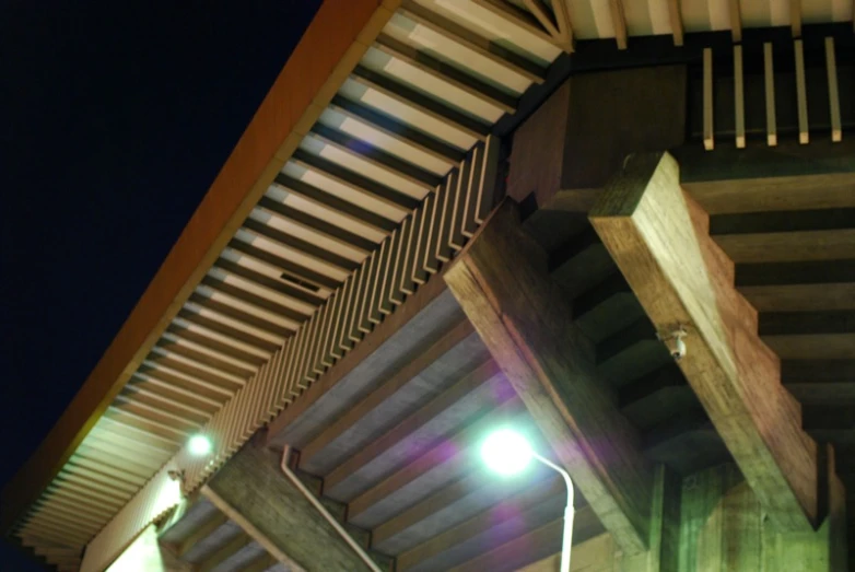 two street lamps next to some concrete pillars