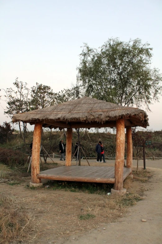 a wooden platform has a thatched roof