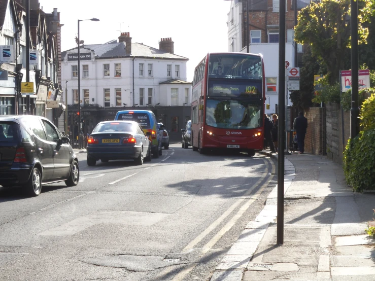 a double decker bus is driving down the street