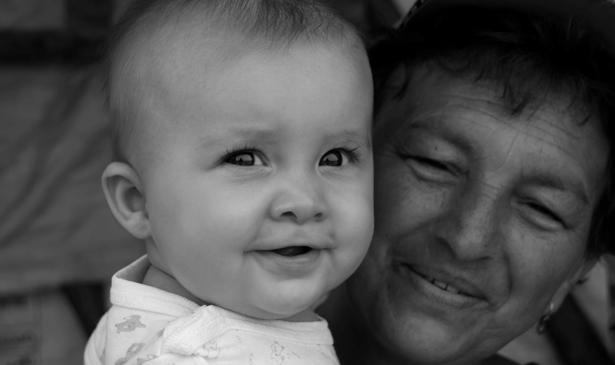 a woman with a hat hugging a baby