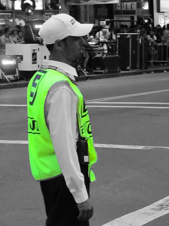 a person wearing a safety vest walking down a street