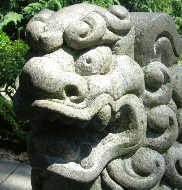 a lion statue with many spirally rings and eyes