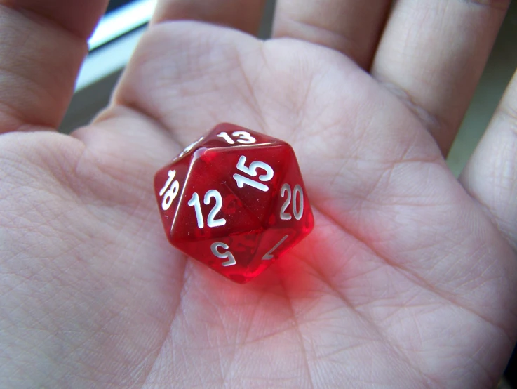 the hand is holding a red dice that reads 32