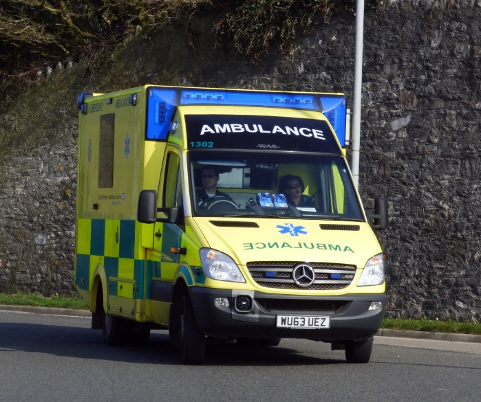 the small yellow vehicle is on the side of the road