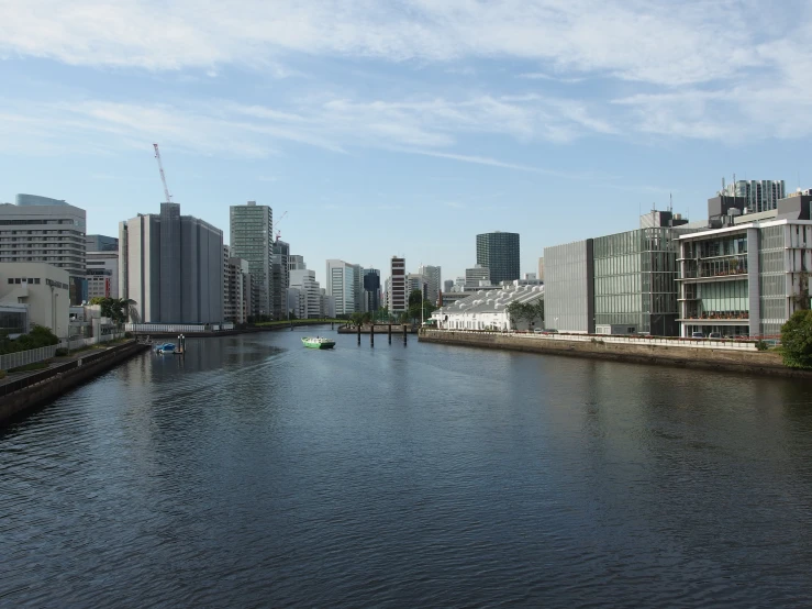 a city is seen from the shore of a waterway