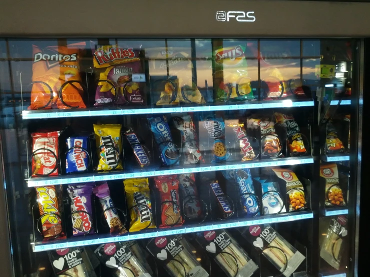 a vending machine displaying many snacks in a store