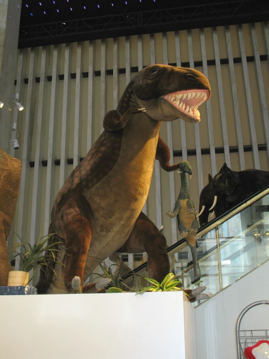 a stuffed dinosaur walking down an escalator