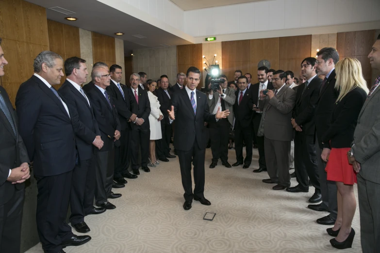 a man in a suit walking into the room