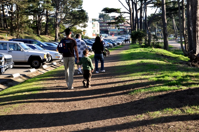 people are walking on the side of a road