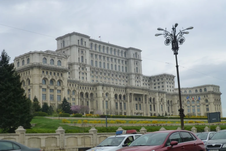 cars are parked in front of a large building