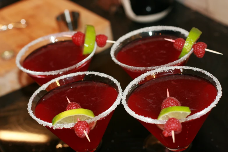 four glasses with different kinds of fruit on them