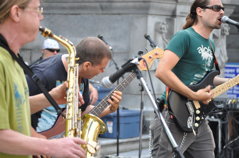 some men are playing instruments at an outdoor concert