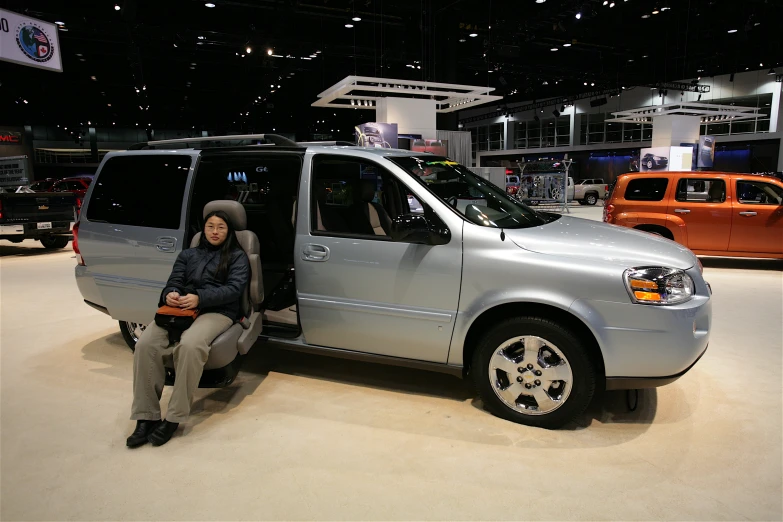 a person in a minivan with several other vehicles in the background