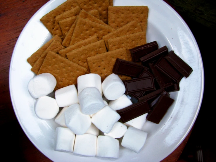 marshmallows and graham ers sit on a white plate