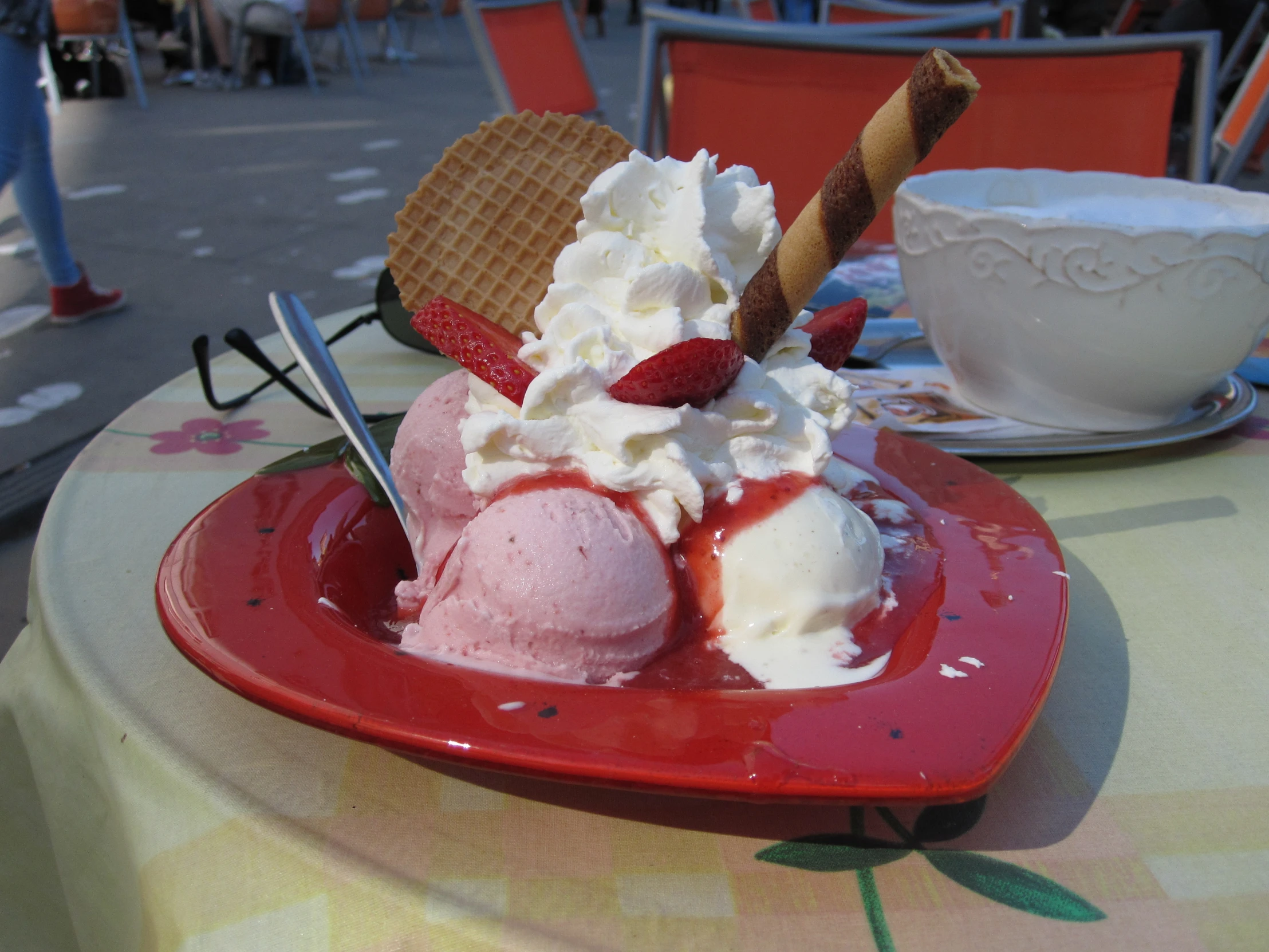 a plate with an ice cream sundae and some fruit