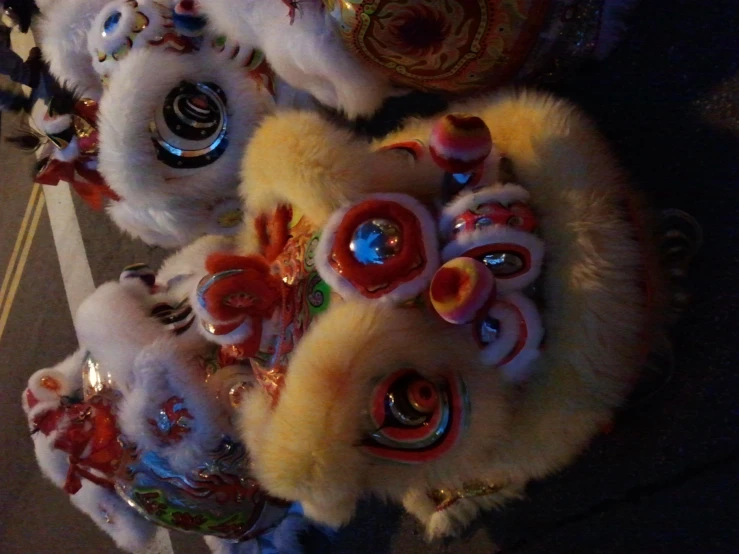 some brightly dressed animal heads lined up in front of each other