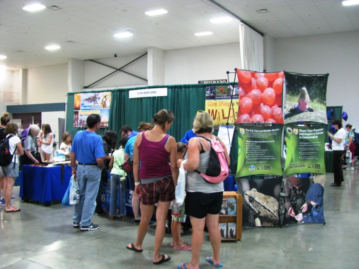 there are several people that are looking at a display