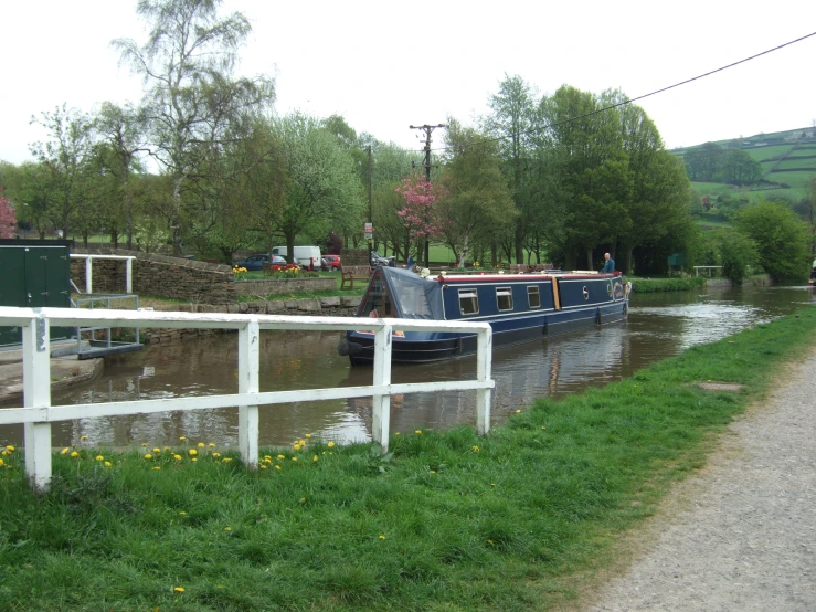 a canal boat is docked on a body of water