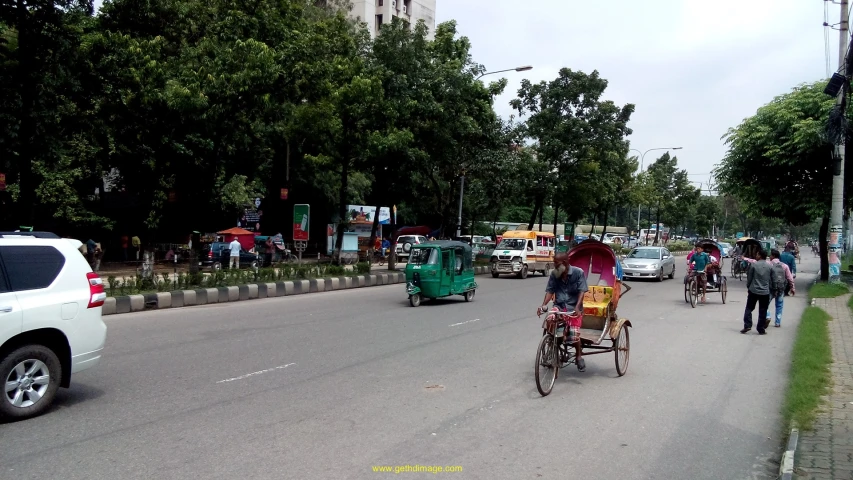 people are riding in carts on a street