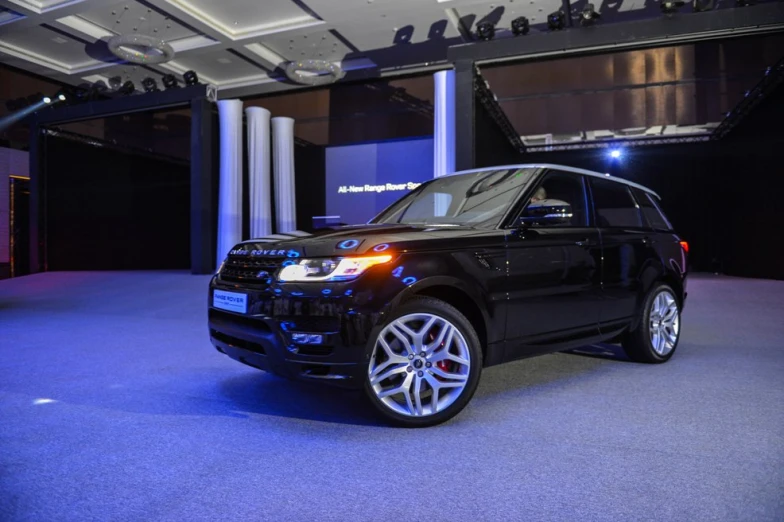 the car is parked in the garage on a show floor